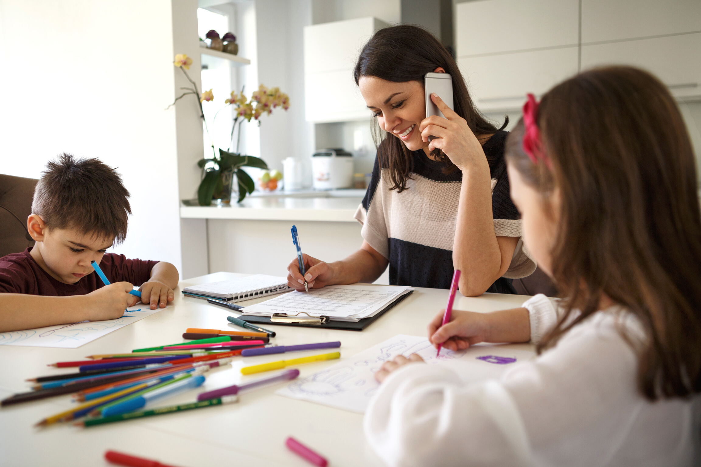 Working mom using mobile phone at home